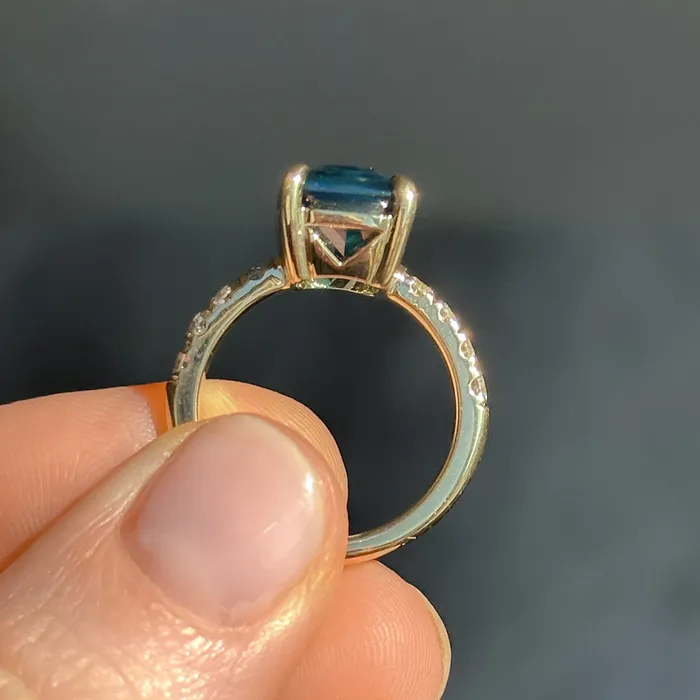 Rings 612ct Deep Teal Blue Madagascar Radiant Cut Sapphire Solitaire Ring with French Set Diamonds in 18k Yellow Gold Anueva Jewelry